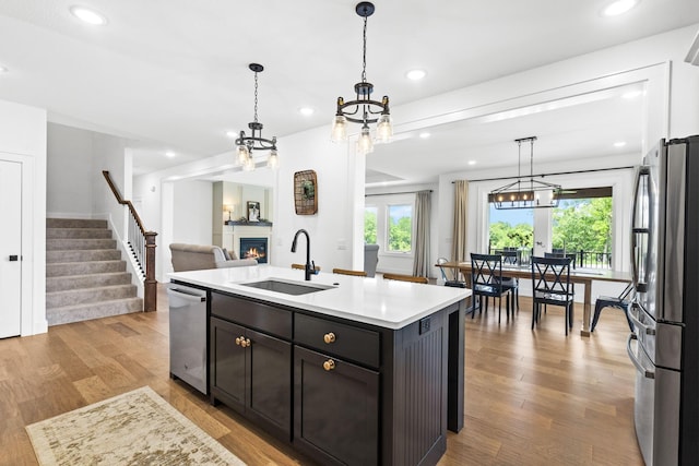 4531 E Hidden Oak St, Springfield, MO 65802 - kitchen with a sink, stainless steel appliances, a glass covered fireplace, plenty of natural light, and recessed lighting