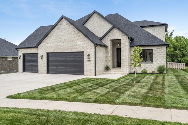4531 E Hidden Oak St, Springfield, MO 65802 - french provincial home featuring a garage, concrete driveway, brick siding, and a shingled roof
