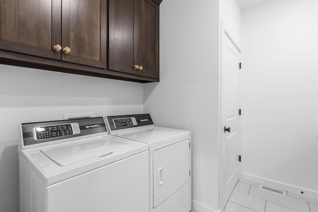 4531 E Hidden Oak St, Springfield, MO 65802 - washroom with cabinet space, washing machine and clothes dryer, baseboards, and light tile patterned floors