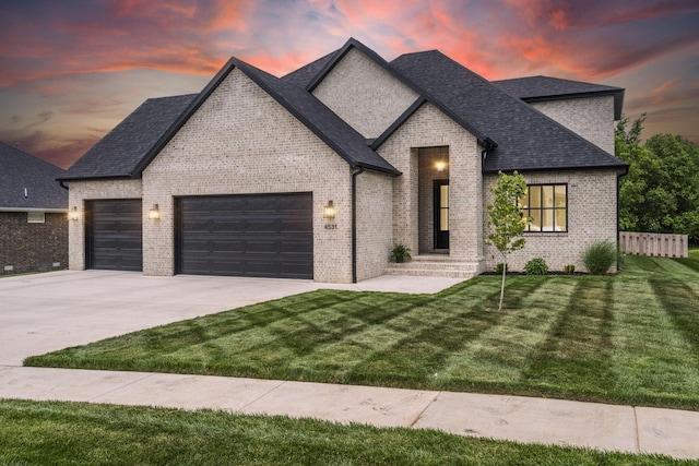 4531 E Hidden Oak St, Springfield, MO 65802 - french country inspired facade featuring a garage, brick siding, driveway, and roof with shingles