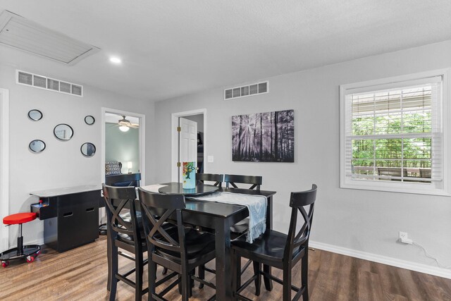 17 Montague Ln, Kimberling City, MO 65686 - dining area featuring wood finished floors, baseboards, ceiling fan, and attic access