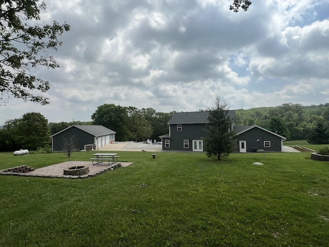 1995 Corder Pass Rd, Mansfield, MO 65704 - view of grassy yard with an outdoor fire pit, an outdoor structure, and a patio