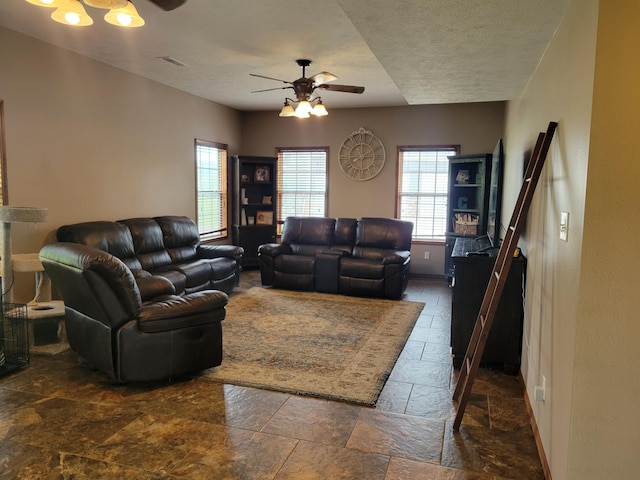 1995 Corder Pass Rd, Mansfield, MO 65704 - living room with stone tile floors, a ceiling fan, healthy amount of natural light, baseboards, and a textured ceiling