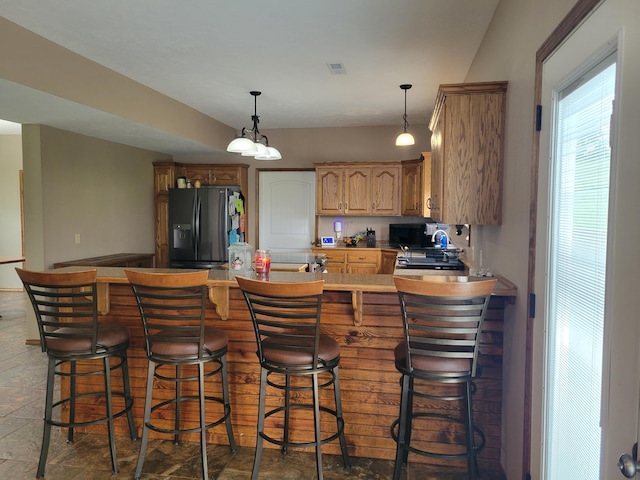 1995 Corder Pass Rd, Mansfield, MO 65704 - kitchen with black appliances, a peninsula, light brown cabinets, and decorative light fixtures