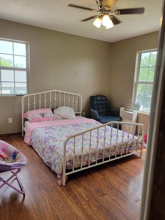 1995 Corder Pass Rd, Mansfield, MO 65704 - bedroom featuring multiple windows, wood finished floors, and a ceiling fan