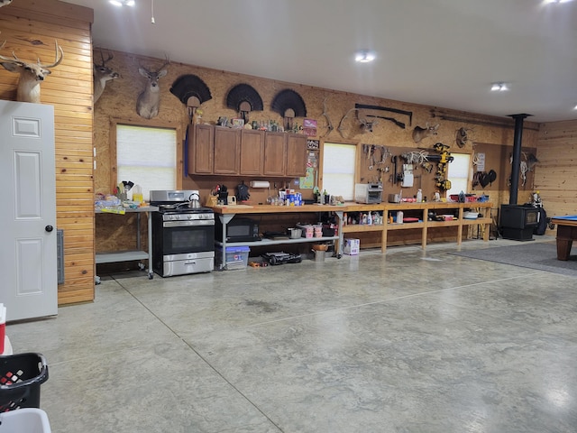 1995 Corder Pass Rd, Mansfield, MO 65704 - garage featuring wood walls and a wood stove