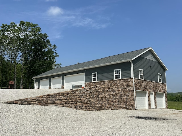 1995 Corder Pass Rd, Mansfield, MO 65704 - view of home's exterior with stone siding, an attached garage, and driveway