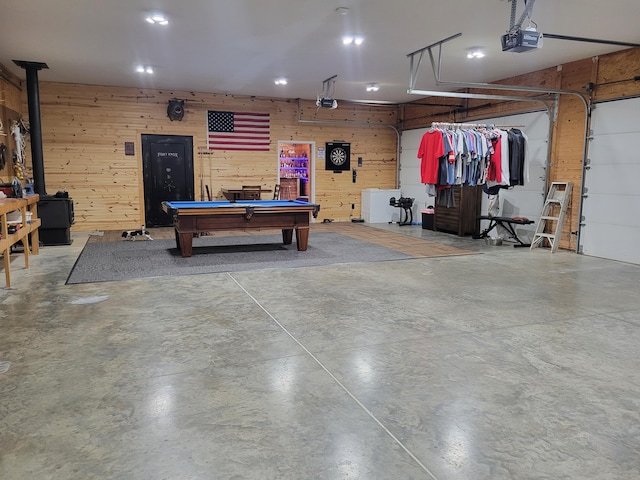 1995 Corder Pass Rd, Mansfield, MO 65704 - garage featuring wood walls, a wood stove, and a garage door opener