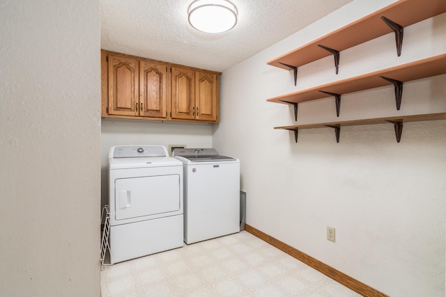 150 Sunken Forest Dr Unit 190, Forsyth, MO 65653 - washroom featuring washing machine and clothes dryer, cabinet space, light floors, a textured ceiling, and baseboards