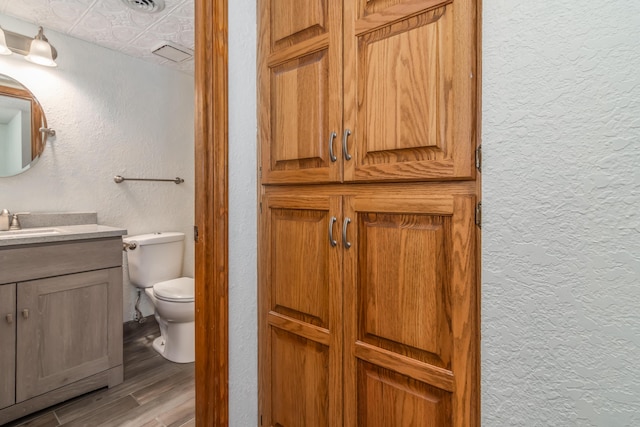 150 Sunken Forest Dr Unit 190, Forsyth, MO 65653 - bathroom featuring a textured wall, toilet, wood finished floors, vanity, and an ornate ceiling