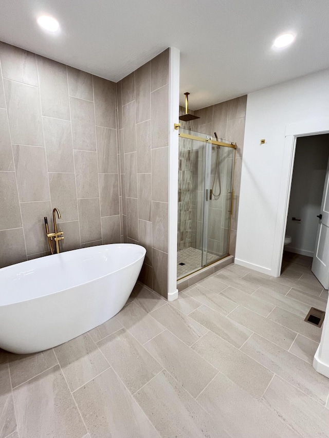 2077 N Sun Valley Dr, Springfield, MO 65802 - full bath featuring a shower stall, a soaking tub, recessed lighting, baseboards, and toilet