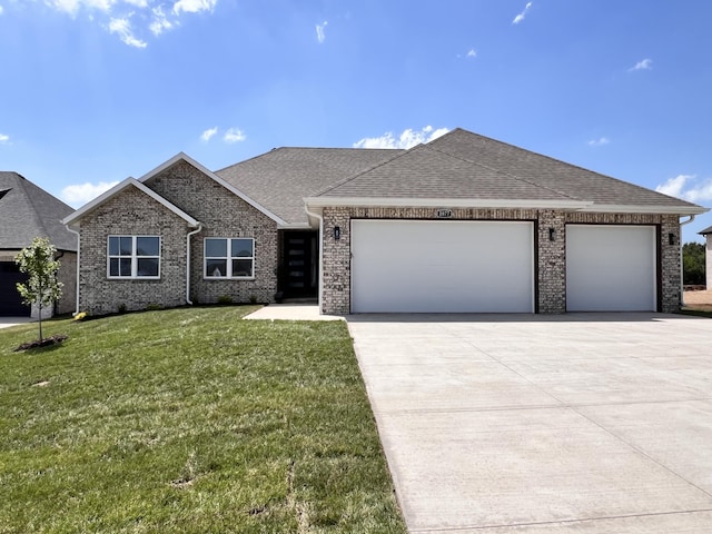 2077 N Sun Valley Dr, Springfield, MO 65802 - view of front of property with driveway, an attached garage, a front lawn, and a shingled roof