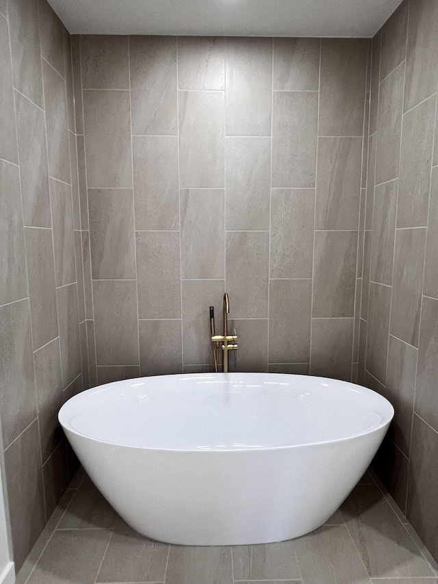 2077 N Sun Valley Dr, Springfield, MO 65802 - bathroom with a soaking tub and tile walls