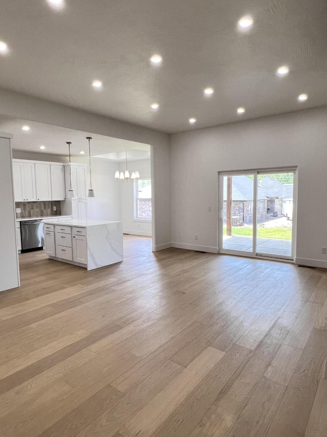 2077 N Sun Valley Dr, Springfield, MO 65802 - kitchen with stainless steel dishwasher, open floor plan, light wood-style flooring, plenty of natural light, and recessed lighting