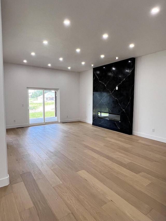 2077 N Sun Valley Dr, Springfield, MO 65802 - empty room with a high end fireplace, light wood-type flooring, baseboards, and recessed lighting