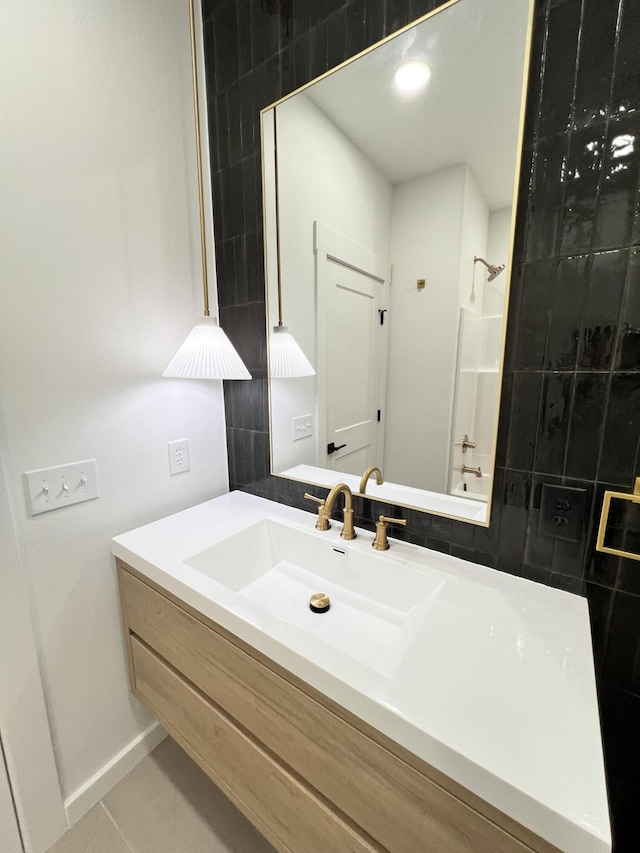 2077 N Sun Valley Dr, Springfield, MO 65802 - bathroom with a shower, vanity, and baseboards