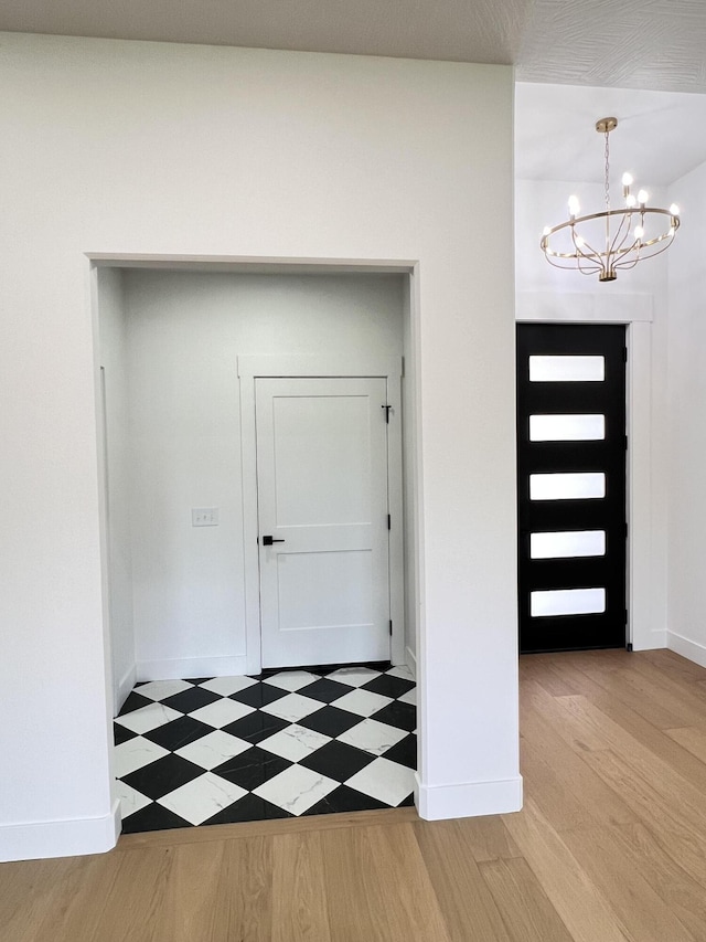 2077 N Sun Valley Dr, Springfield, MO 65802 - foyer with a chandelier, wood finished floors, and baseboards