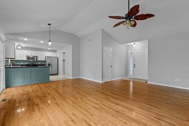 805 S Benson Pl, Nixa, MO 65714 - unfurnished living room with lofted ceiling, light wood-style floors, a ceiling fan, baseboards, and a sink