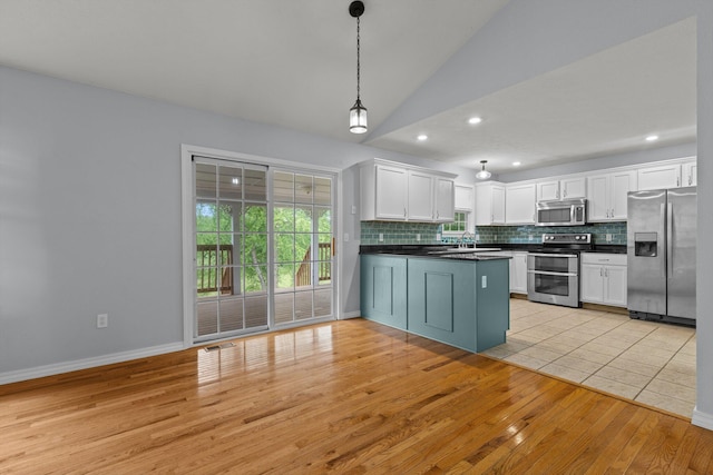 805 S Benson Pl, Nixa, MO 65714 - kitchen featuring appliances with stainless steel finishes, dark countertops, tasteful backsplash, light wood finished floors, and lofted ceiling