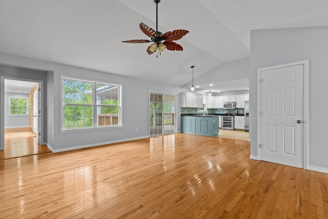 805 S Benson Pl, Nixa, MO 65714 - unfurnished living room featuring lofted ceiling, ceiling fan, light wood-type flooring, plenty of natural light, and baseboards