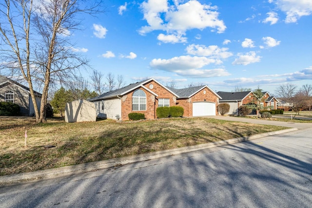 805 S Benson Pl, Nixa, MO 65714 - single story home with concrete driveway, brick siding, a garage, a front lawn, and a storage unit