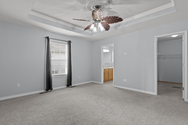 805 S Benson Pl, Nixa, MO 65714 - unfurnished bedroom with a raised ceiling, light carpet, ornamental molding, a spacious closet, and baseboards