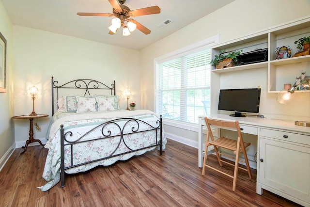 bedroom featuring baseboards, dark wood-style floors, and a desk