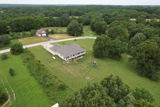 view of subject property with a heavily wooded area