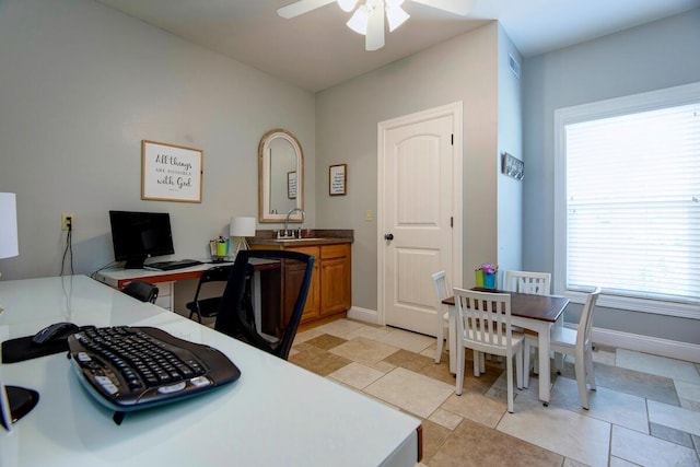 home office featuring a ceiling fan, baseboards, and a sink