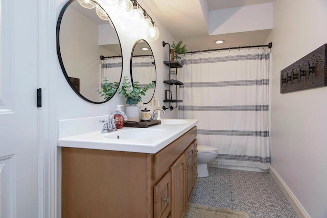 full bath featuring vanity, toilet, baseboards, and tile patterned flooring