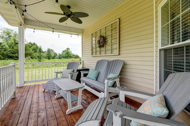 wooden terrace featuring a ceiling fan
