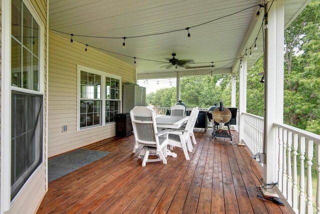 wooden terrace featuring ceiling fan and outdoor dining space