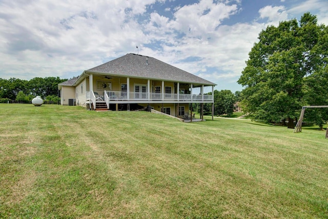 back of property with a yard, ceiling fan, a wooden deck, and central AC unit