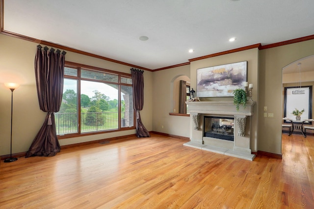 6046 S Parkhaven Ln, Springfield, MO 65810 - unfurnished living room with arched walkways, baseboards, wood finished floors, a fireplace, and ornamental molding