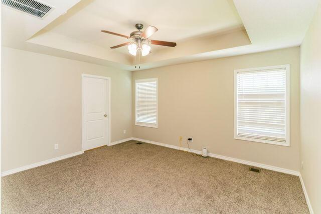 1205 N 12th Ave, Ozark, MO 65721 - carpeted spare room featuring a raised ceiling and a ceiling fan