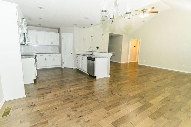 1205 N 12th Ave, Ozark, MO 65721 - kitchen featuring open floor plan, dishwasher, decorative backsplash, white cabinets, and dark wood finished floors