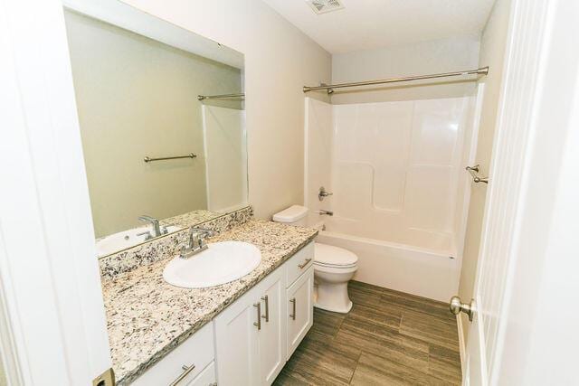 1205 N 12th Ave, Ozark, MO 65721 - full bathroom featuring vanity, washtub / shower combination, and wood finished floors