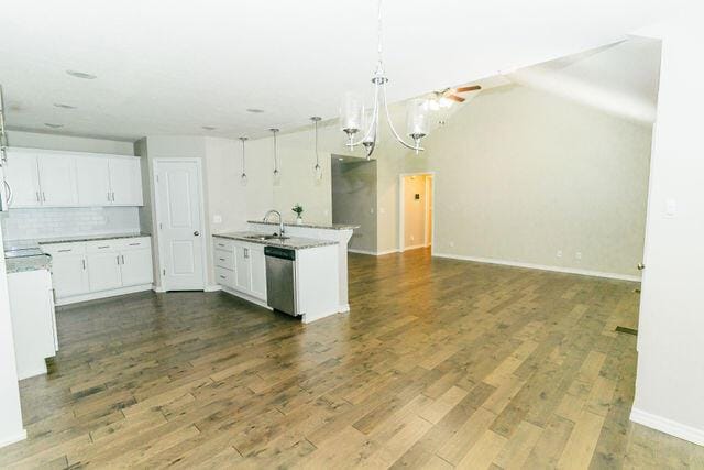 1205 N 12th Ave, Ozark, MO 65721 - kitchen with dishwasher, open floor plan, a chandelier, decorative backsplash, and dark wood-style floors