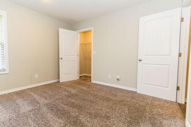 1205 N 12th Ave, Ozark, MO 65721 - unfurnished bedroom with carpet and baseboards