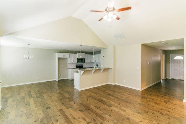 1205 N 12th Ave, Ozark, MO 65721 - unfurnished living room featuring ceiling fan, high vaulted ceiling, dark wood finished floors, and a chandelier