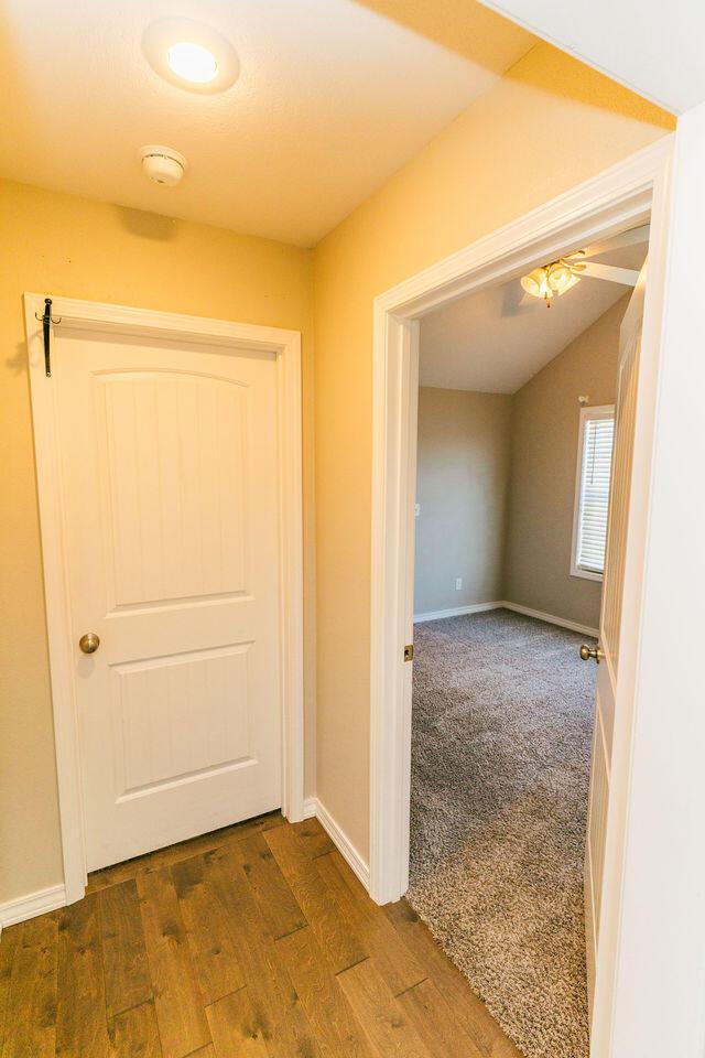 1205 N 12th Ave, Ozark, MO 65721 - hallway with dark wood-style floors and vaulted ceiling