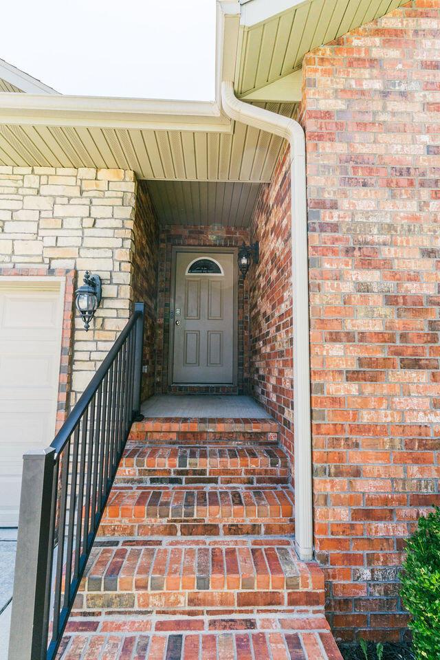 1205 N 12th Ave, Ozark, MO 65721 - view of exterior entry featuring brick siding