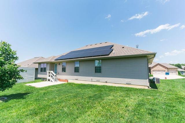 1205 N 12th Ave, Ozark, MO 65721 - back of house with roof mounted solar panels and a yard