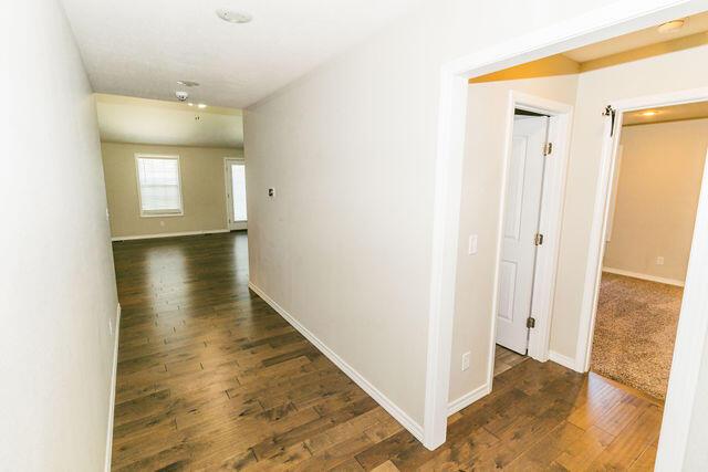 1205 N 12th Ave, Ozark, MO 65721 - hall with wood finished floors and baseboards