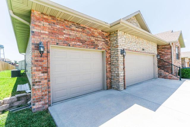1205 N 12th Ave, Ozark, MO 65721 - garage featuring concrete driveway