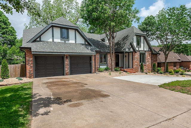 1935 E Canterbury St, Springfield, MO 65804 - tudor-style house featuring fence, brick siding, driveway, and an attached garage