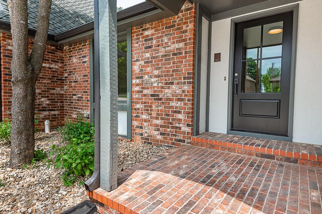 1935 E Canterbury St, Springfield, MO 65804 - property entrance with brick siding and a shingled roof