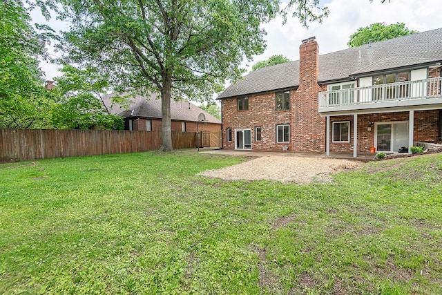 1935 E Canterbury St, Springfield, MO 65804 - rear view of house featuring brick siding, a patio, and a chimney
