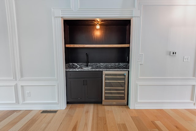1935 E Canterbury St, Springfield, MO 65804 - indoor wet bar featuring beverage cooler and light wood-style flooring