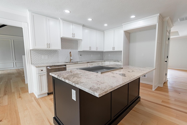 1935 E Canterbury St, Springfield, MO 65804 - kitchen with a sink, stainless steel dishwasher, black electric stovetop, light wood-style floors, and recessed lighting